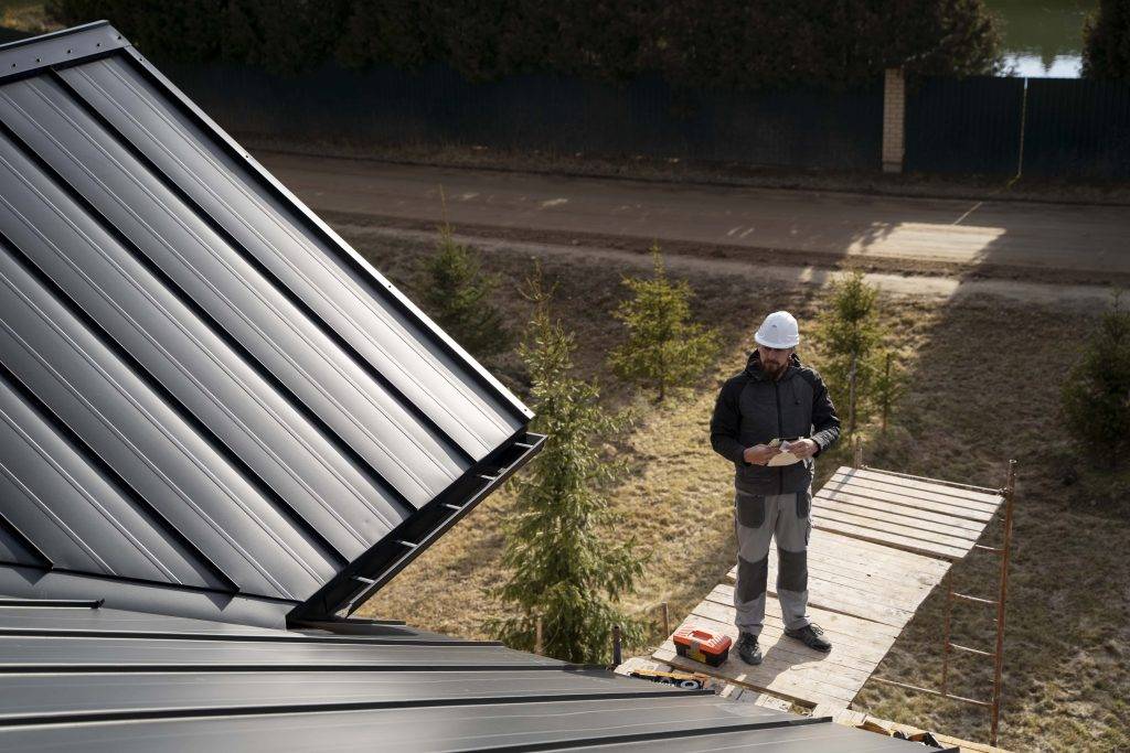 Engineer is inspecting the rain gutter on  platform